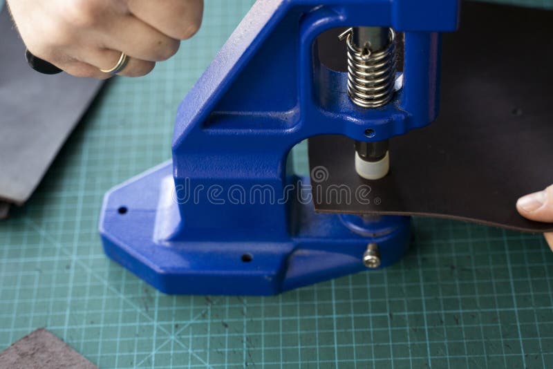 Artisan Using Hand Press for Setting Snaps in Leather for Makes a