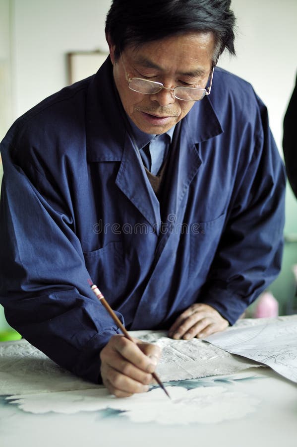 An artist painting traditional Chinese realistic painting.Opposited to the freehand brushwork in traditional Chinese painting (characterized by vivid expression and bold outline), Traditional Chinese realistic painting is characterized by fine brushwork and close attention to detail. Traditional Chinese realistic painting is distinctive result of Chinese culture.Xingtai City, Hebei Province, China, April 26, 2012.