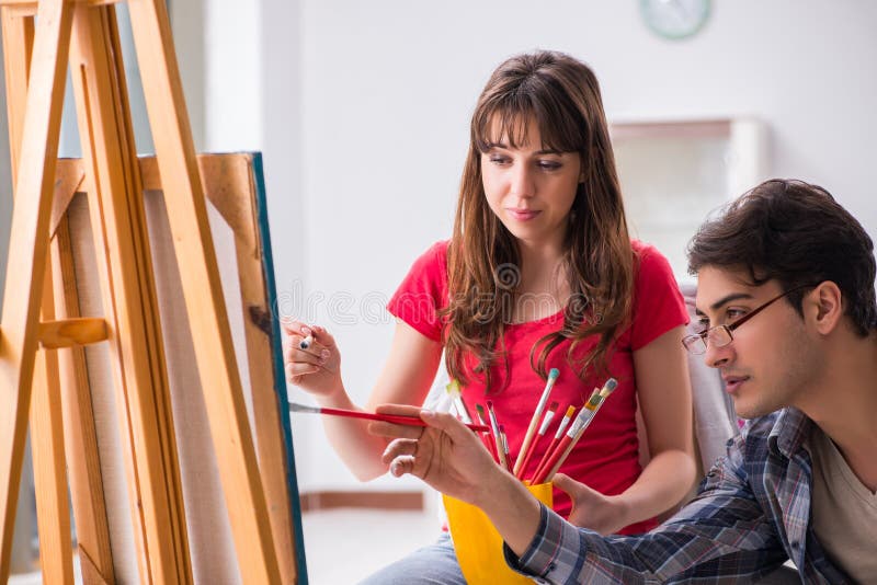 The Artist Coaching Student in Painting Class in Studio Stock Photo