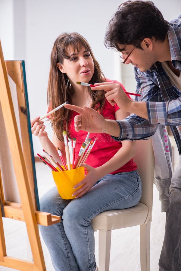 The Artist Coaching Student in Painting Class in Studio Stock Image