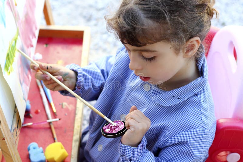 Artist little girl painting watercolors portrait