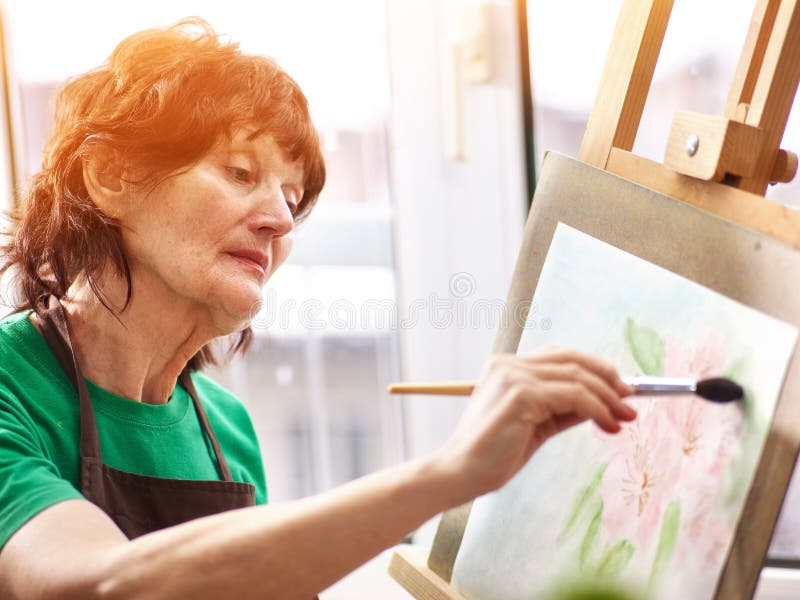 Artist painting easel in studio. Authentic senior woman. royalty free stock photo Artist painting easel in studio. Authentic senior woman. royalty free stock photo
