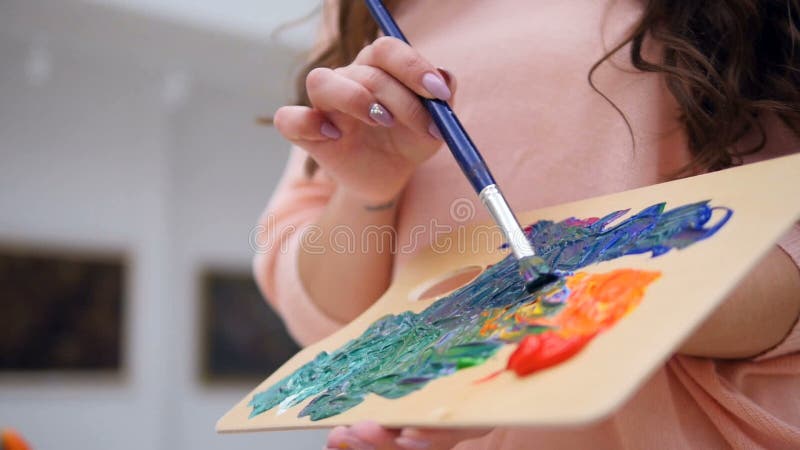 Artist painting with oil paints..