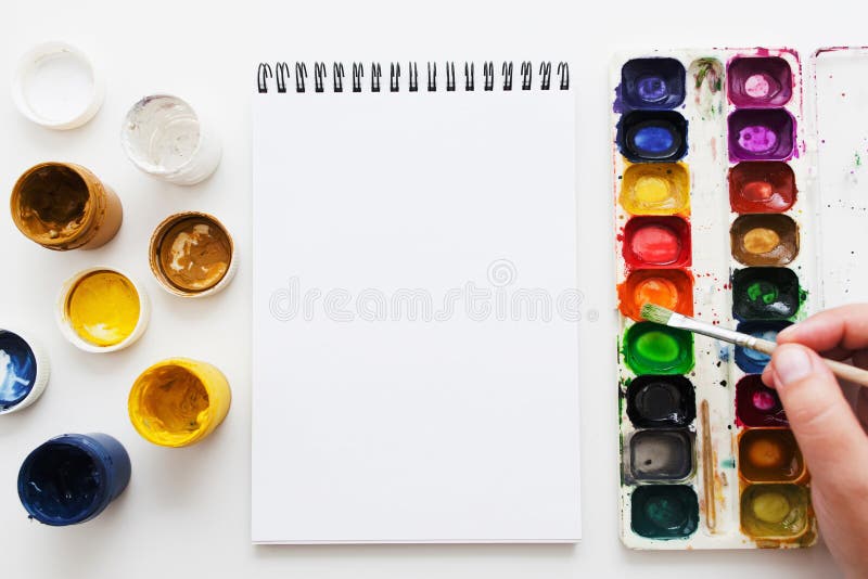 Artist painting with watercolor dye flat lay