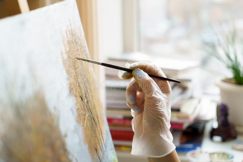 Artist`s hand draws oil painting close up stock images Artist`s hand draws oil painting close up stock images