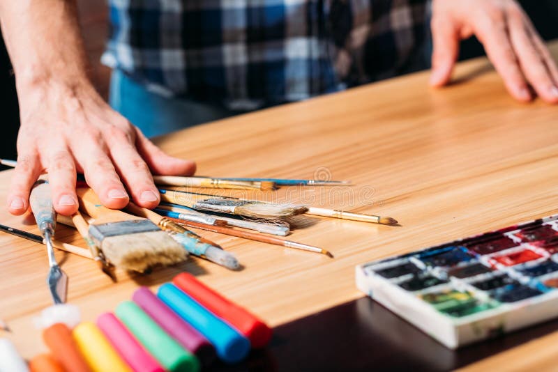 Artist tools paintbrushes man hands art process