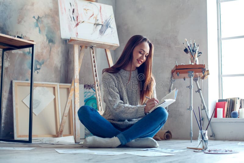 Artista da jovem mulher que pinta em casa o planeamento criativo imagem de stock Artista da jovem mulher que pinta em casa o planeamento criativo imagem de stock