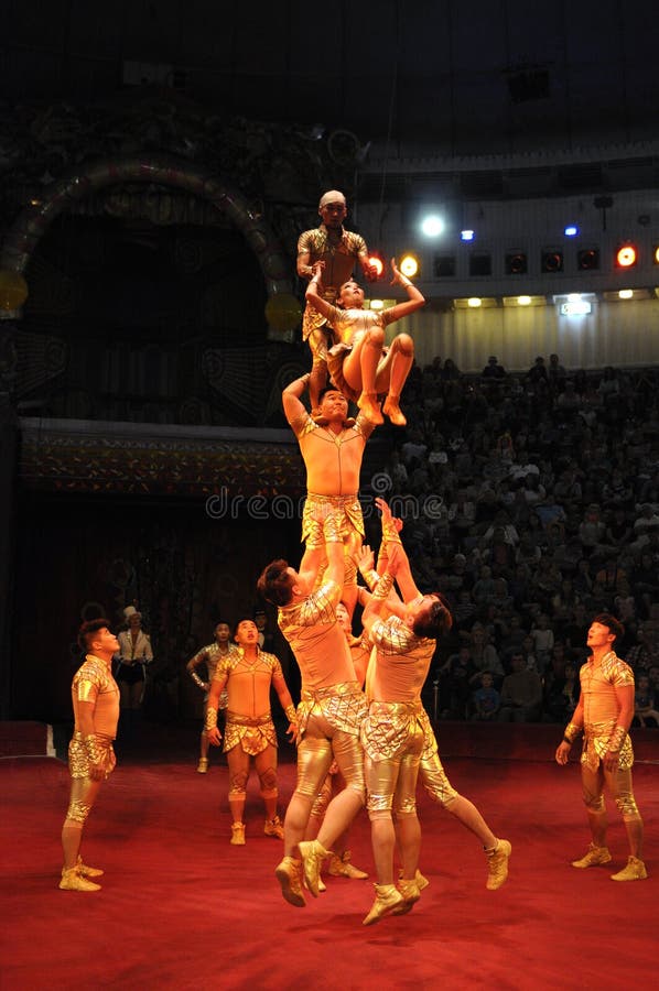 Acrobat asian artists performing on the ring of the National Kiev circus. June 10, 2015. Kiev, Ukraine. Acrobat asian artists performing on the ring of the National Kiev circus. June 10, 2015. Kiev, Ukraine