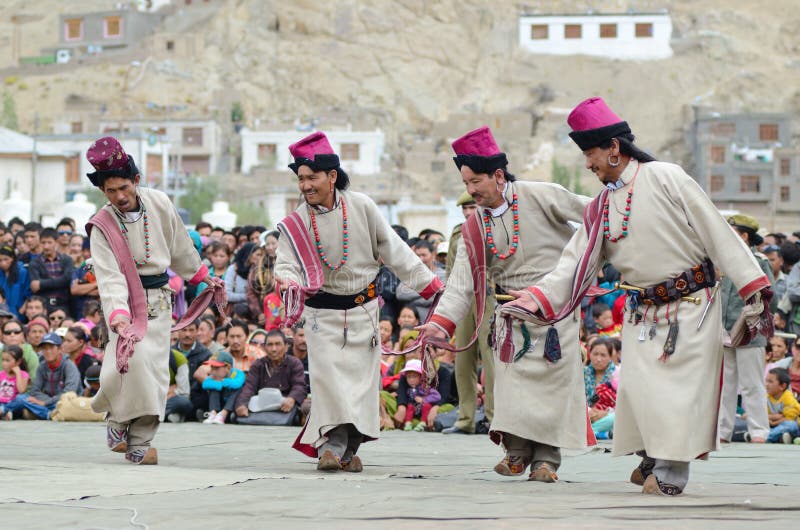 LEH, LADAKH, INDIA - SEPTEMBER 08, 2012: Artists in traditional tibetan costumes performing folk dance. Last day of Annual Festival of Ladakh Heritage in Leh, India. September 08, 2012. LEH, LADAKH, INDIA - SEPTEMBER 08, 2012: Artists in traditional tibetan costumes performing folk dance. Last day of Annual Festival of Ladakh Heritage in Leh, India. September 08, 2012.