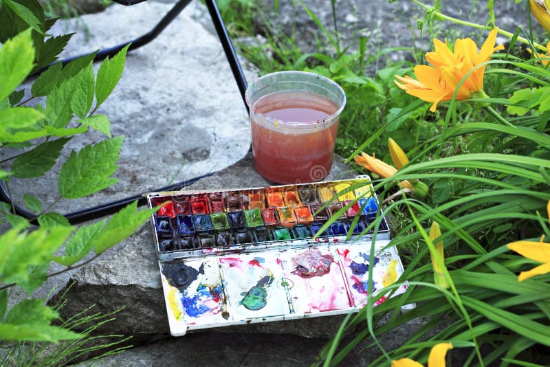 Artists paints box in garden