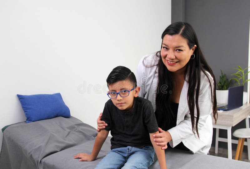 Latina doctor and boy patient with autism spectrum disorder, a developmental disability caused by differences in the brain. Latina doctor and boy patient with autism spectrum disorder, a developmental disability caused by differences in the brain