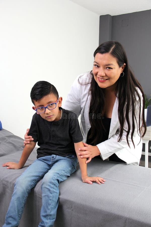 Latina doctor and boy patient with autism spectrum disorder, a developmental disability caused by differences in the brain. Latina doctor and boy patient with autism spectrum disorder, a developmental disability caused by differences in the brain