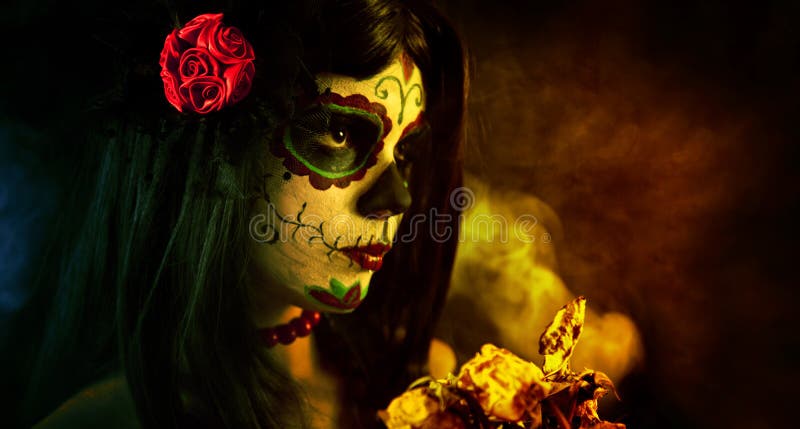 Artistic shot of sugar skull girl with dead roses, selective focus on rose. Artistic shot of sugar skull girl with dead roses, selective focus on rose