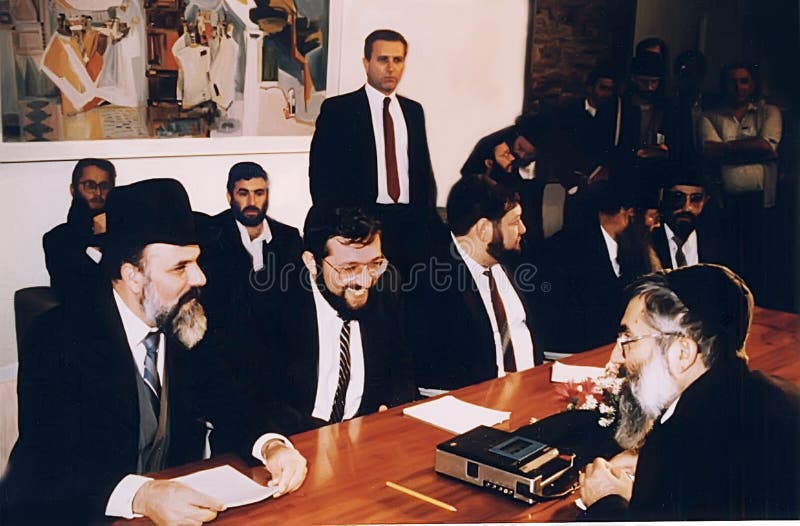 Previous Shas Party leader Yitzhak Peretz, outgoing Interior Minister, meets with Arye Deri, to his left, and other members of the Shas Party in the Knesset in December, 1988.  Deri became the youngest government minister at 29, even though he had not formally run for the position in an election.  In any case, a few years later he ran and won a Knesset Parlianment seat.  But in 1999 he was convicted of fraud, bribery, and breech of trust, and served 2 years in prison.  In 2013 he ran again and won.  In 2022, he was convicted of tax crimes.  The Israel Supreme Court said this disqualified him for a seat in the Netanyahu government in Januaary, 2023.  His fate remains uncertain.  Shas is Sephardic Orthodox religious party with a large working class constituency of Moroccan Jewish descent. Previous Shas Party leader Yitzhak Peretz, outgoing Interior Minister, meets with Arye Deri, to his left, and other members of the Shas Party in the Knesset in December, 1988.  Deri became the youngest government minister at 29, even though he had not formally run for the position in an election.  In any case, a few years later he ran and won a Knesset Parlianment seat.  But in 1999 he was convicted of fraud, bribery, and breech of trust, and served 2 years in prison.  In 2013 he ran again and won.  In 2022, he was convicted of tax crimes.  The Israel Supreme Court said this disqualified him for a seat in the Netanyahu government in Januaary, 2023.  His fate remains uncertain.  Shas is Sephardic Orthodox religious party with a large working class constituency of Moroccan Jewish descent.