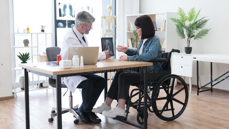 Erwachsener Arzt Mit Digitaler Tablette, in Der Der Patient Im Krankenhaus  Auf Rollstuhl Erklärt Wird Stockfoto - Bild von erklären, doktor: 168040970