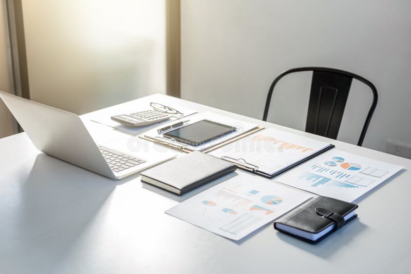 Images of Tax Invoice, business strategy graph, Digital tabet and white calculator on table in office. Images of Tax Invoice, business strategy graph, Digital tabet and white calculator on table in office.