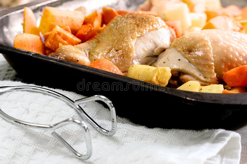 Portions of chicken roasted in a baking tray with carrots, parsnips and sweet potatoes. Portions of chicken roasted in a baking tray with carrots, parsnips and sweet potatoes.