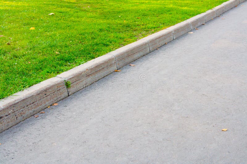 Asphalted road and green grass. Asphalted road and green grass