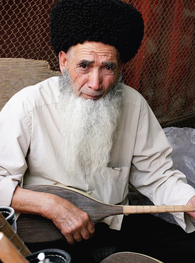 Ashgabat, Turkmenistan - March 09. Portrait of Turkmen man in telpek with bushy beard. Oriental bazaar. Ashgabat, Turkmenistan - March 09. 2013. Ashgabat, Turkmenistan - March 09. Portrait of Turkmen man in telpek with bushy beard. Oriental bazaar. Ashgabat, Turkmenistan - March 09. 2013.