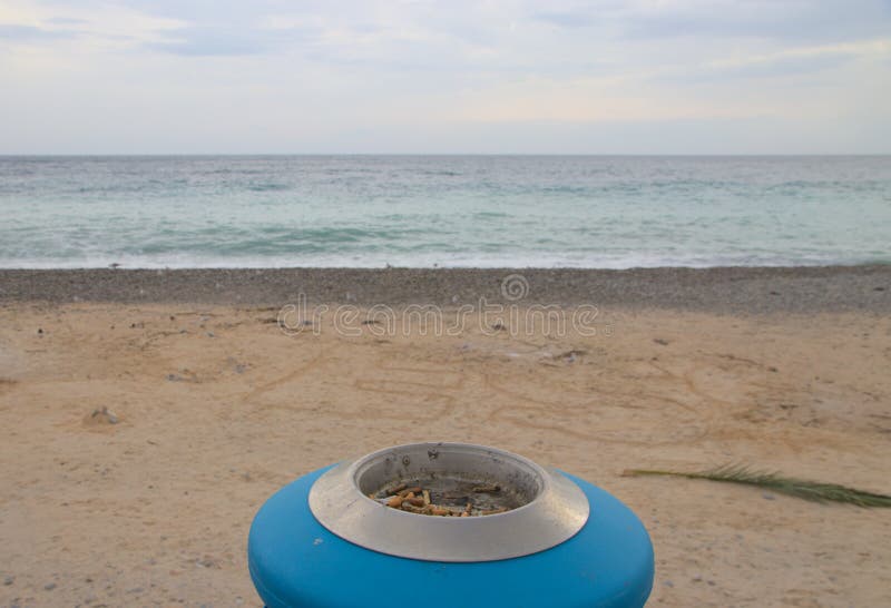 Ashtray on the beach stock image. Image of filter, white 223894399