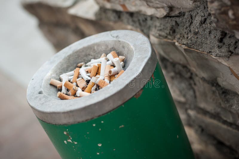 Ashtray Full of Cigarettes and Ashes. Real Life Scene Stock Photo