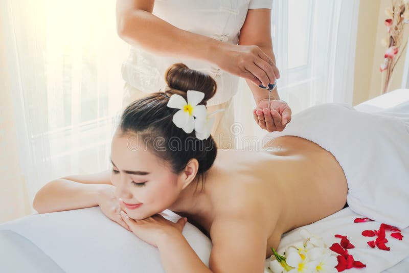 Asia beautiful woman during massage with essential oil in room spa royalty free stock photo Asia beautiful woman during massage with essential oil in room spa royalty free stock photo
