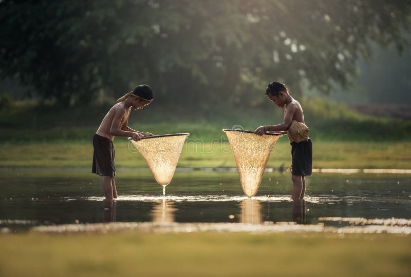Asia boys fishing in the lake stock image Asia boys fishing in the lake stock image