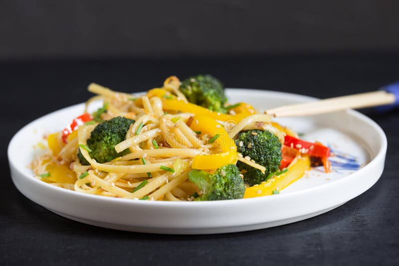 Asia food. Stir fry udon noodles with vegetables on the black table, cooked in wok royalty free stock photography Asia food. Stir fry udon noodles with vegetables on the black table, cooked in wok royalty free stock photography