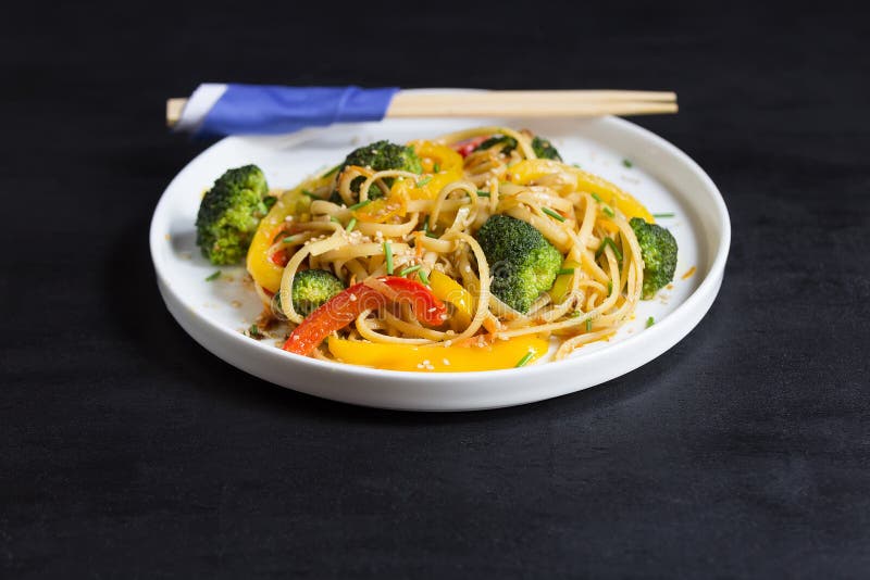 Asia food. Stir fry udon noodles with vegetables on the black table, cooked in wok with copy space royalty free stock images Asia food. Stir fry udon noodles with vegetables on the black table, cooked in wok with copy space royalty free stock images