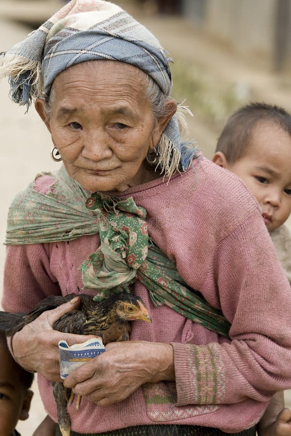 Asia, old woman with chicken and grandson