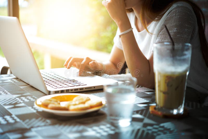 Asia beuatiful woman Using Laptop In Coffee Shop. Asia beuatiful woman Using Laptop In Coffee Shop