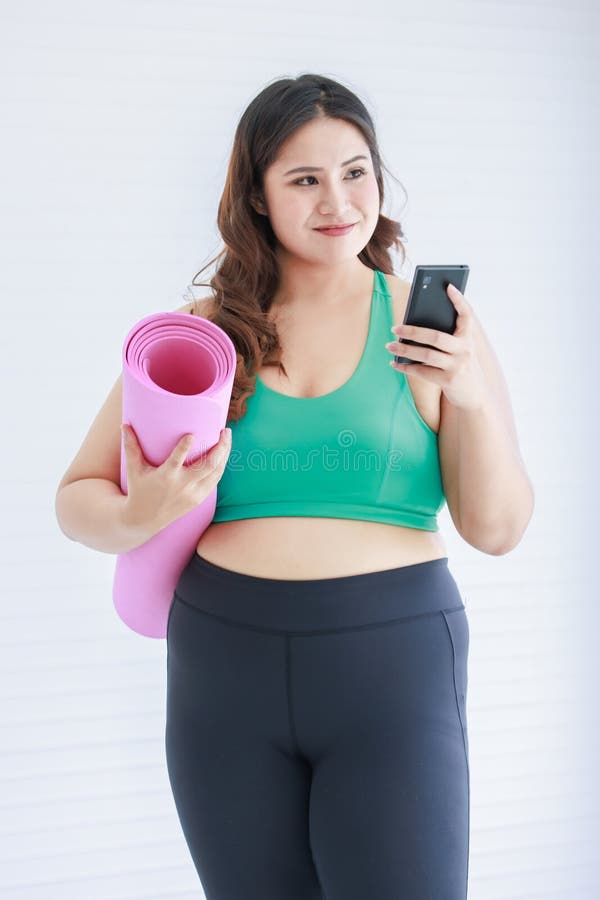 Premium Photo  Confident pretty plump woman in sport bra holding