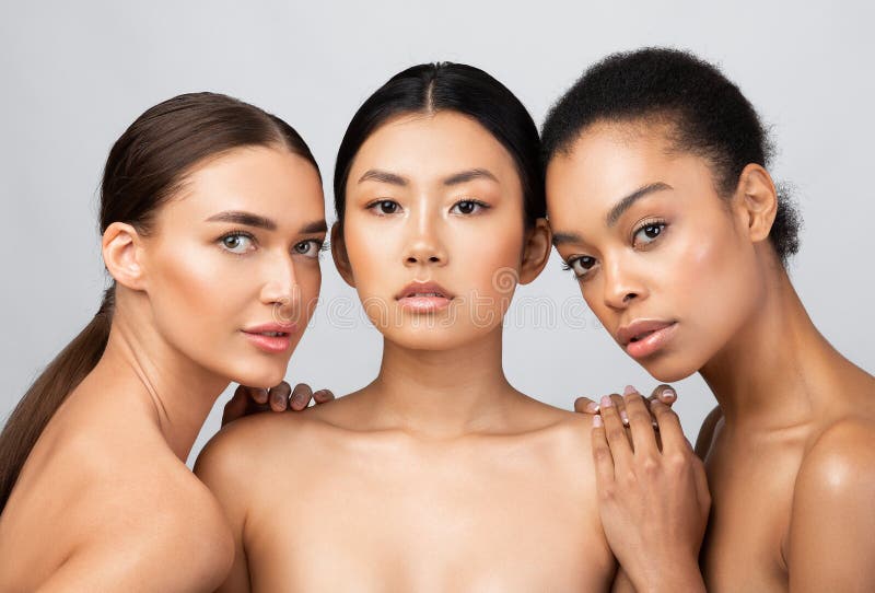 Three glad diverse millennial women in undergarments sit on floor, enjoy  body positivity Stock Photo by Prostock-studio