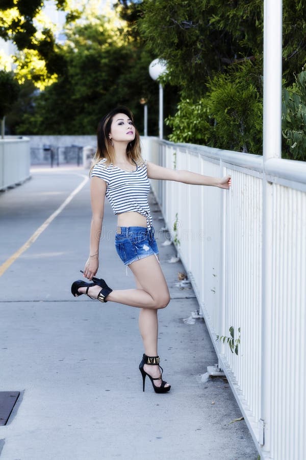 Asian American Woman Sitting in Jean Shorts and Top Stock Image - Image ...