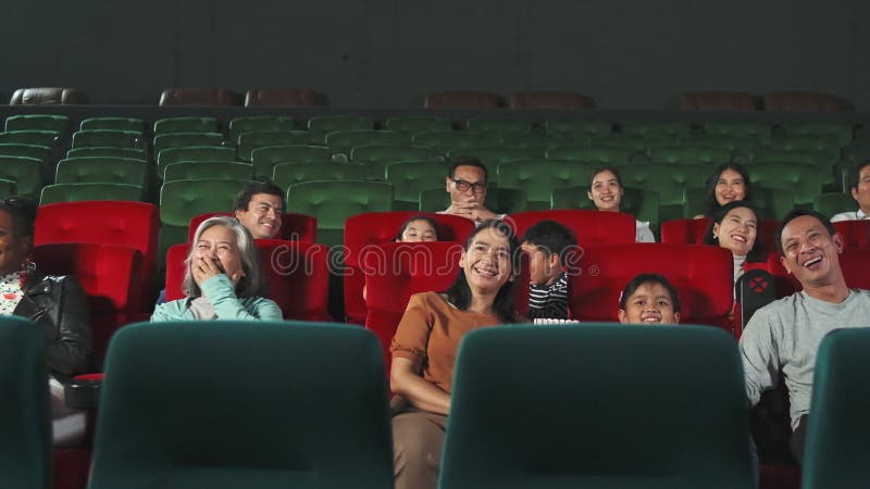 An Asian audience enjoys watching cinema together at movie theaters.