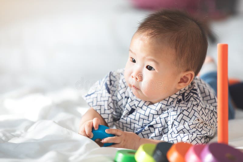 Asian baby playing in crib stock photo. Image of baby 45584012