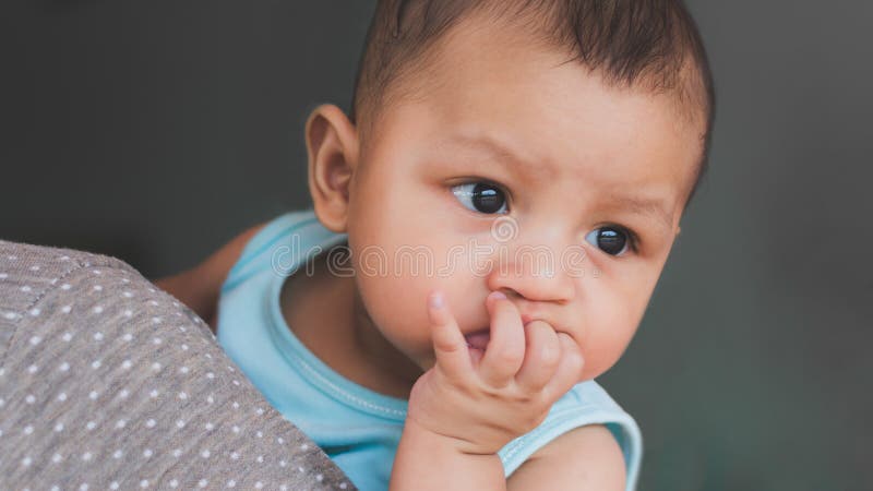 Asian baby boy sucking fingers