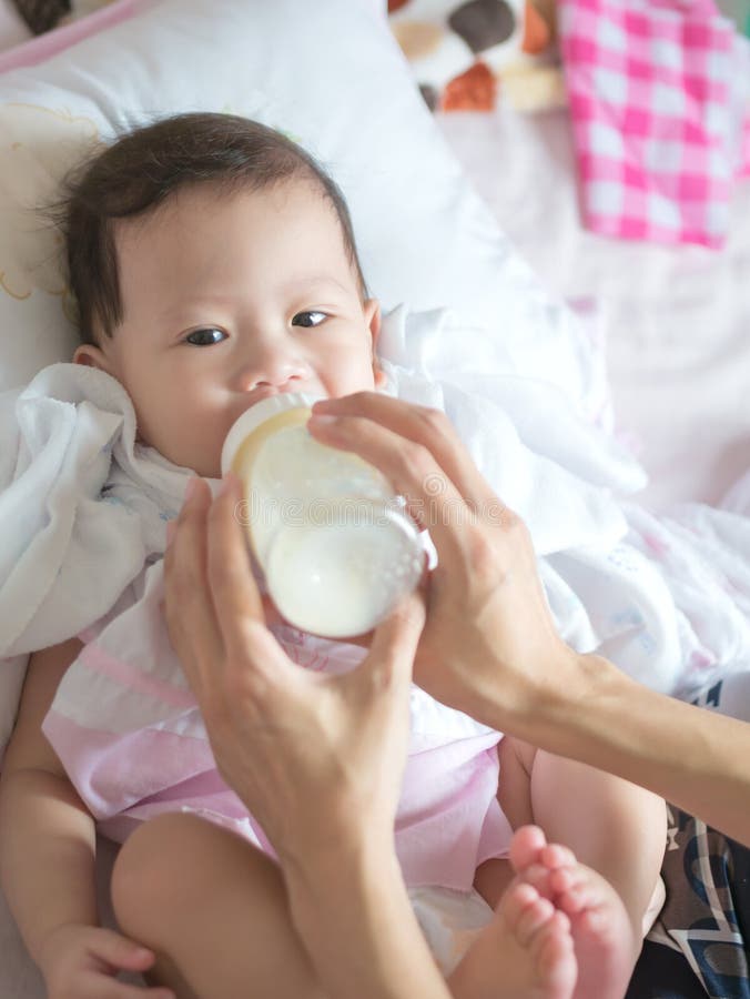 Asian Baby Eat Milk from Bottle. Stock Photo Image of home, family