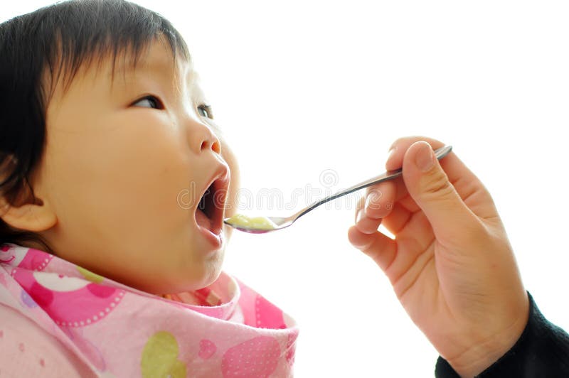 A Asian baby girl eating