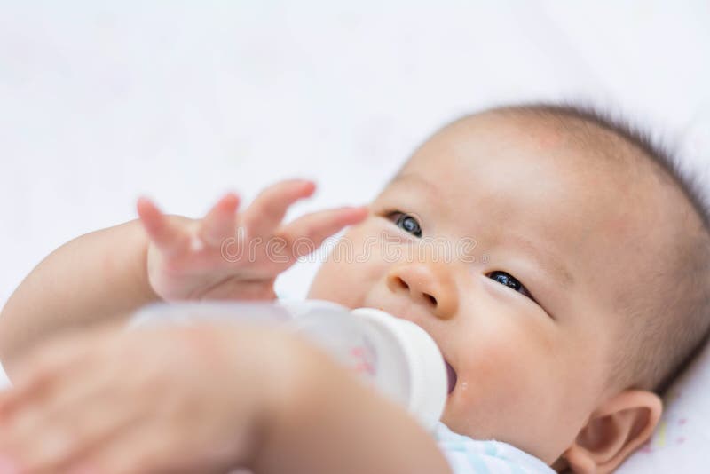 Asian baby infant enjoy drinking water from bottle stock photos Asian baby infant enjoy drinking water from bottle stock photos