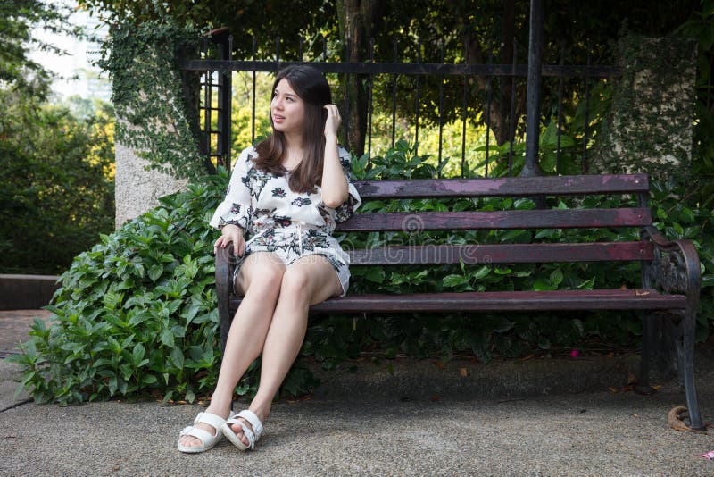 Asian Beautiful Young Woman Sitting on Bench in Outdoor Garden Stock ...