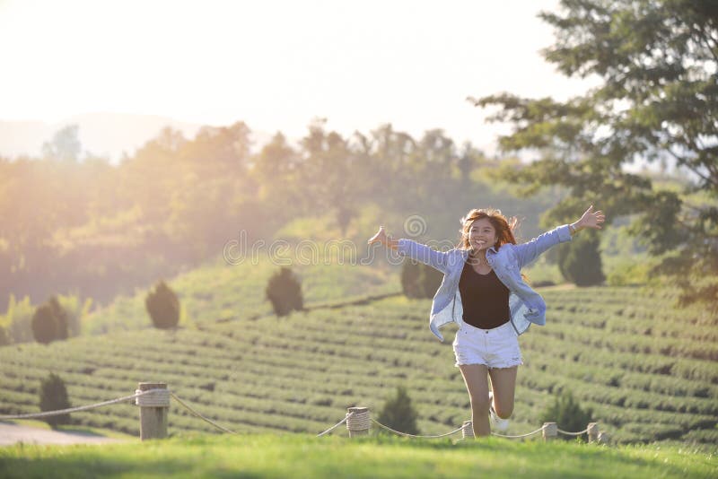 Asian Beauty Girl Outdoors enjoying nature, raising handsand run. Beau stock photos Asian Beauty Girl Outdoors enjoying nature, raising handsand run. Beau stock photos