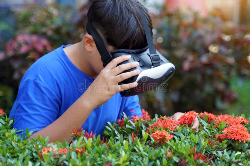 Asian boy enjoys exploring virtual worlds with Virtual Reality Headsets