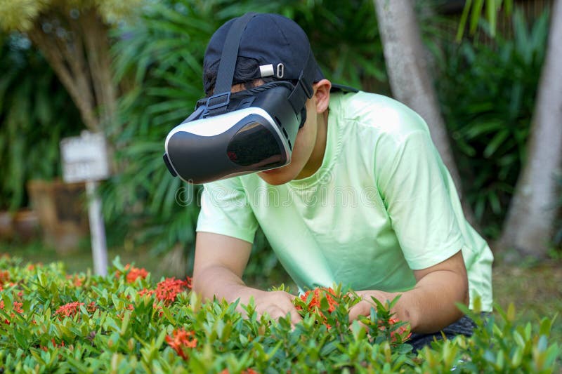 Asian boy enjoys exploring virtual worlds with Virtual Reality Headsets