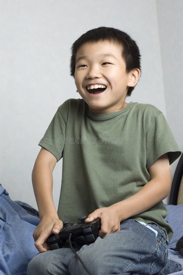 FILE--A young boy plays electronic games on an XBOX ONE game console at a  physical store of Microsoft in Shanghai, China, 26 December 2014. Produc  Stock Photo - Alamy