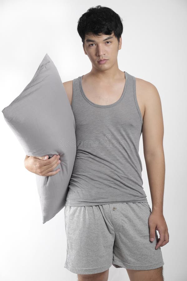 Asian boy in gray pajamas with a pillow royalty free stock images Asian boy in gray pajamas with a pillow royalty free stock images