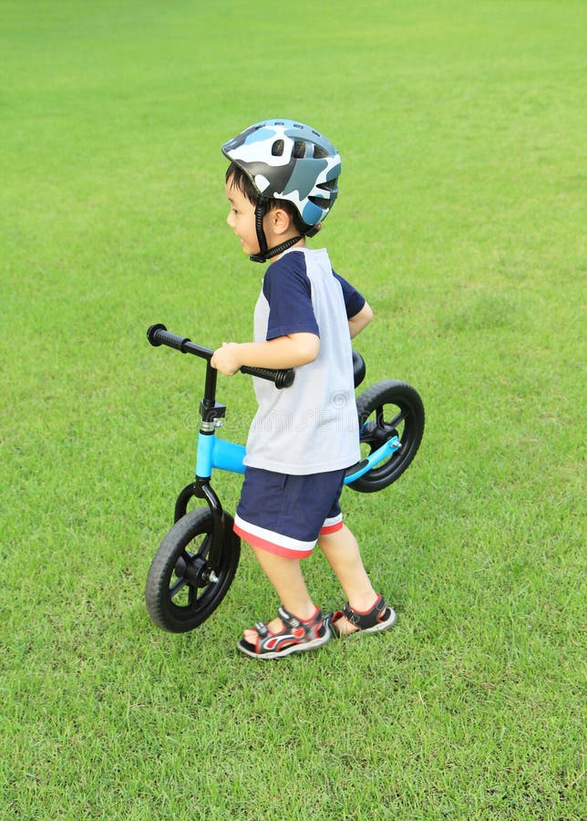 Asian boy holding his bicycle