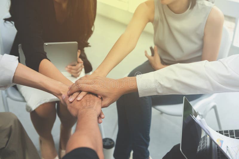 Asian business people group join the hand for collaboration and support, team work concept stock image
