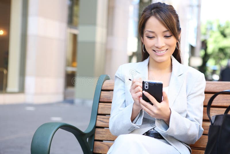 Asian Business Woman on Bench Outside Office