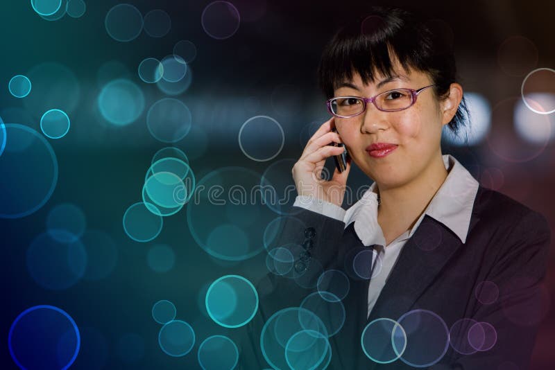 Asian business woman posing with mobile phone against colorful retro circles. Asian business woman posing with mobile phone against colorful retro circles